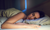 A person sleeping peacefully in a dimly lit room.