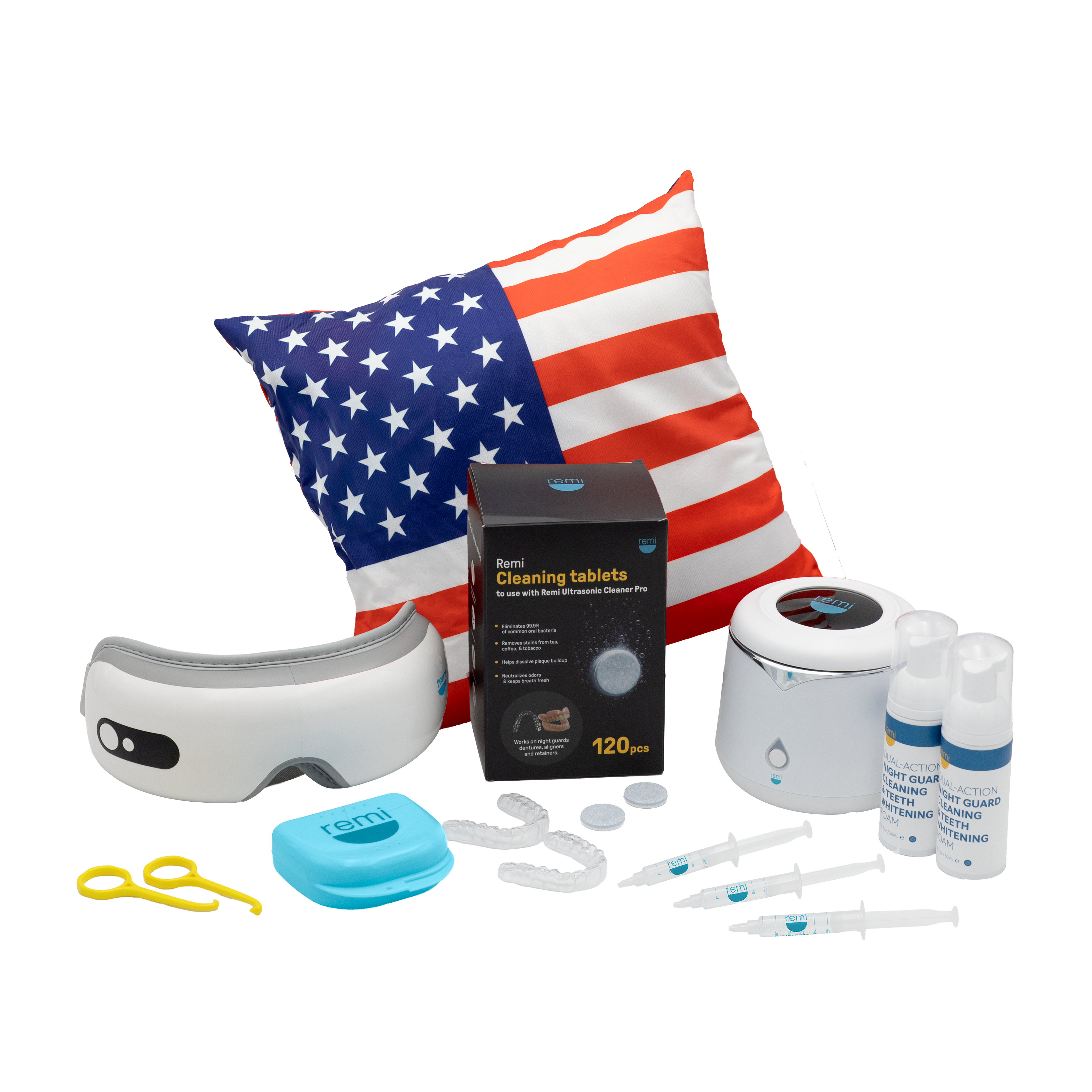A collection of dental care products, including teeth whitening essentials, an eye mask, cleaning tablets, mouth trays, syringes, two spray bottles, a blue case, yellow tweezers, and a pillow with an American flag design.