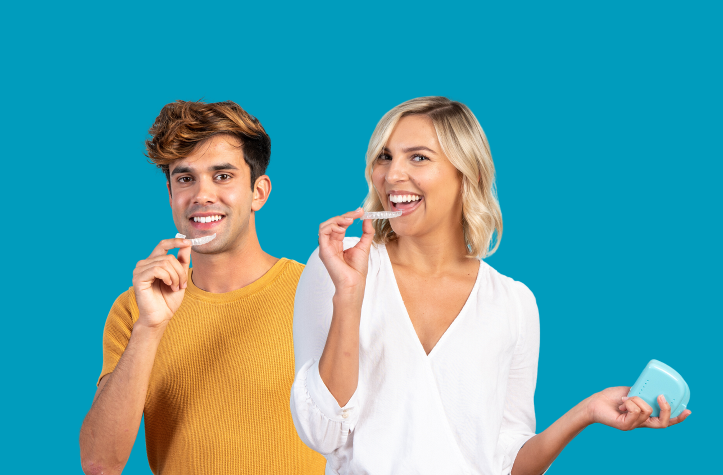 Two people brushing their teeth and smiling against a blue background.