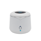 A white cylindrical device with a rounded top, featuring a teardrop-shaped button and a blue logo reading “remi” on the front. The device has a modern, minimalist design.