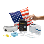 A hand holds a clear dental aligner above dental care products, including an ultrasonic cleaner, aligner cleaner, syringes, teeth whitening supplies, a UV sanitizer, a retainer case, tools, and a pillow with an American flag design.