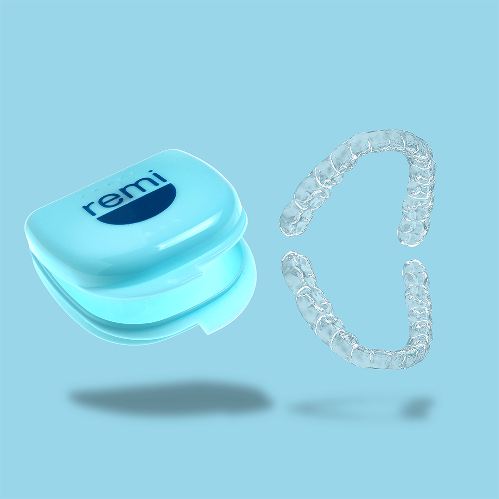 A blue case labeled "Complete Care Retainer Bundle" and a pair of transparent Invisalign aligners rest on a light blue background.