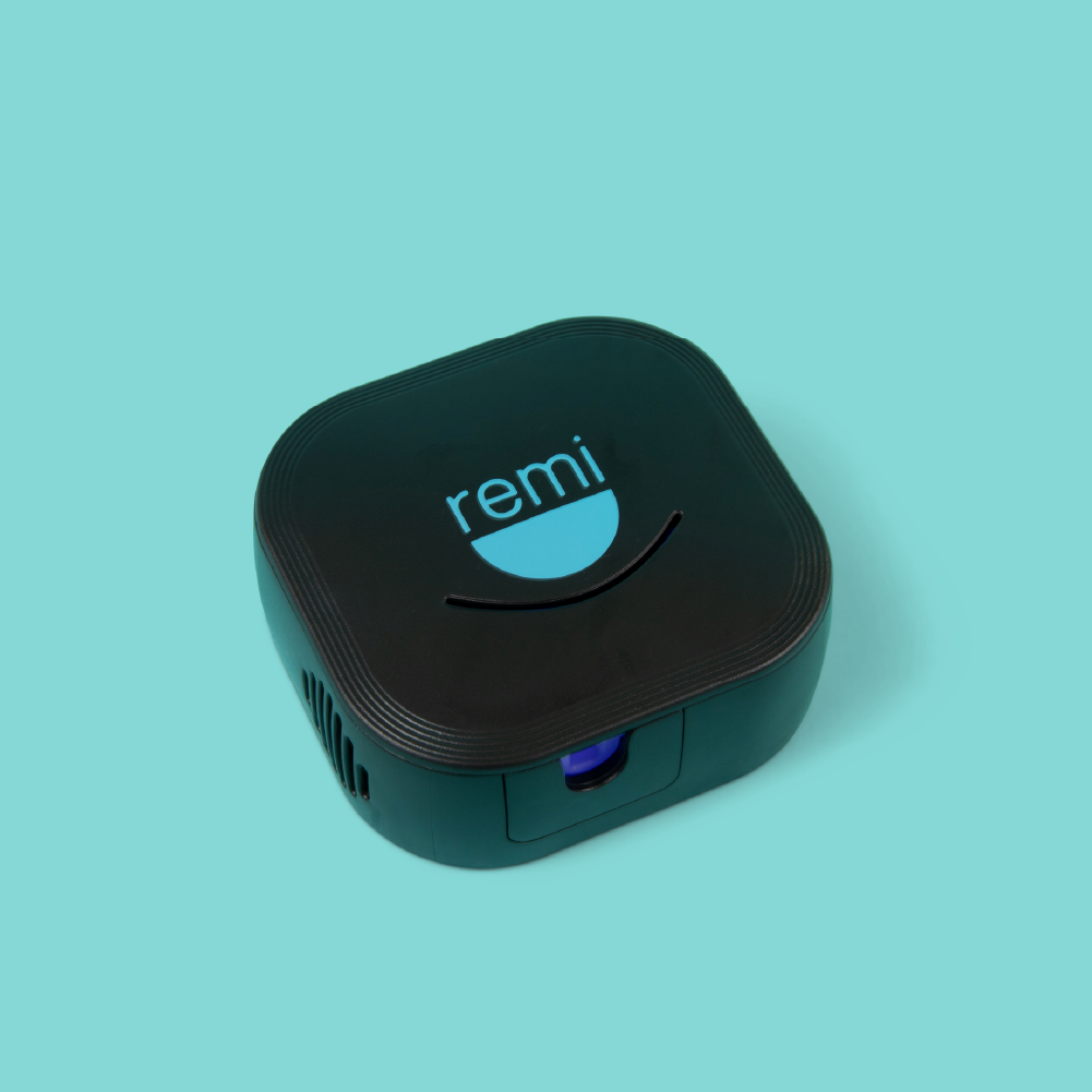 Resting against a turquoise background is the UV Toothbrush Sanitizer, a black, square-shaped device with rounded edges and the word "remi" on top, designed to ensure perfect bacteria elimination.