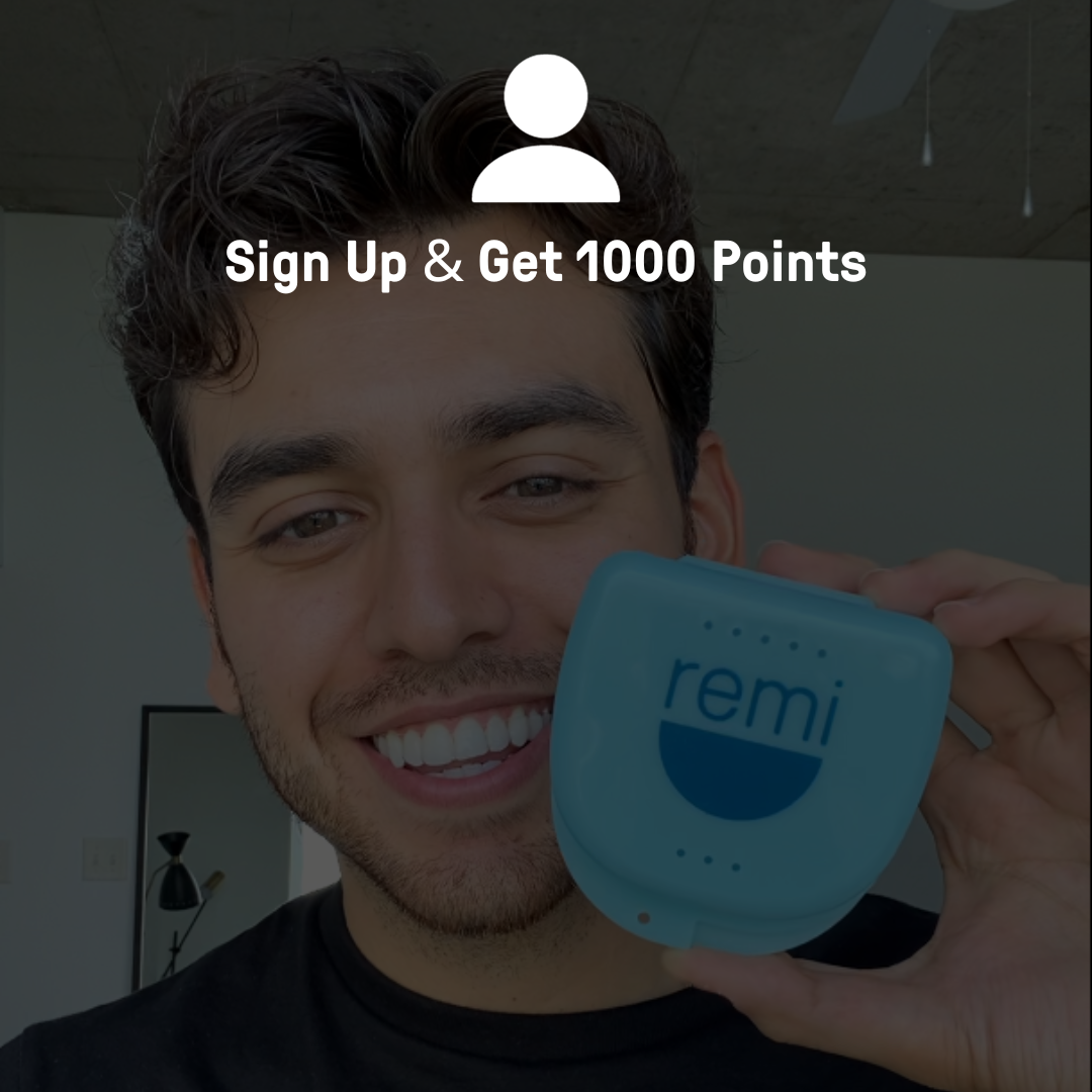 A person smiling while holding up a device with the logo "remi.