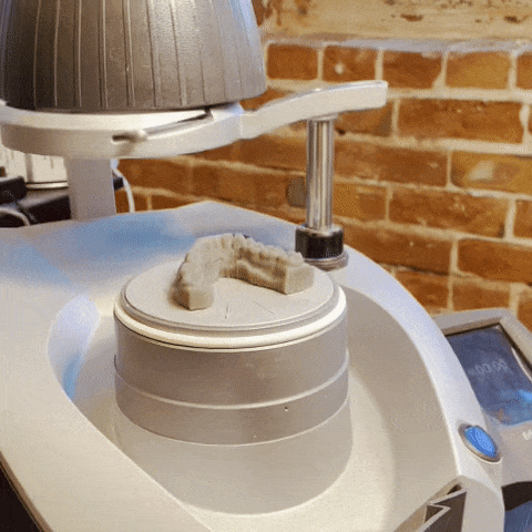 3d milling machine carving a dental model.