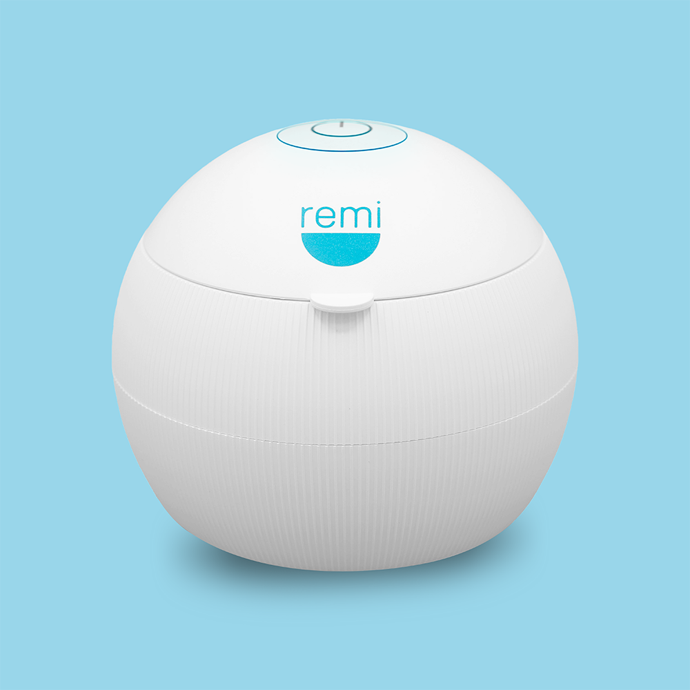 Image of a spherical white device with "remi" printed on its front, set against a light blue background. The sleek design of the Complete Care Retainer Bundle can easily house your Invisalign or retainer, keeping orthodontic tools both safe and stylish.