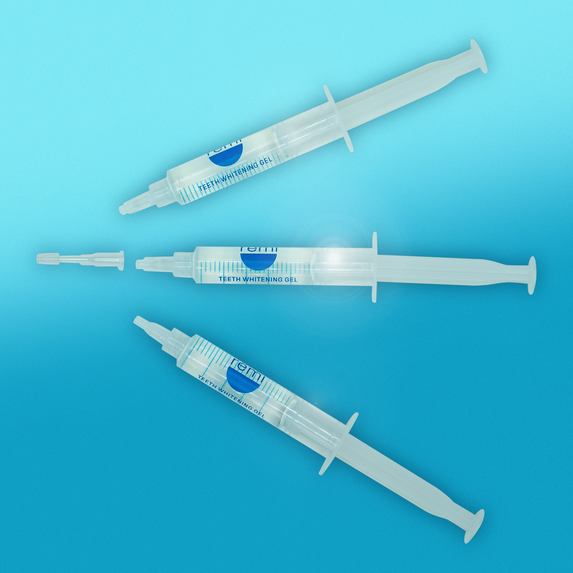 Three Teeth Whitening Gel syringes on a blue background.