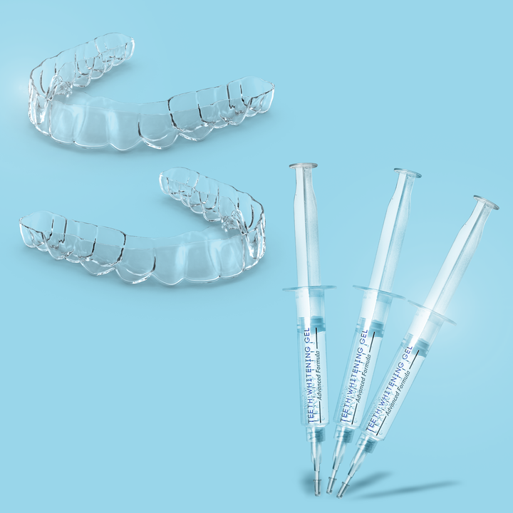 The Custom Whitening Kit, featuring two clear whitening trays and three syringes filled with 10% CP gel, sits on a blue background, offering a convenient home whitening solution.